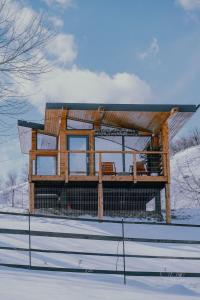 a house being built on top of a snow covered field at Utopia by NorAtlas Heritage - Adults Only in Buzau
