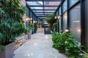 an internal courtyard of a building with plants at Tbilisi Laerton Hotel in Tbilisi City