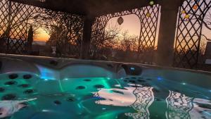 a jacuzzi tub with a sunset in the background at Domaine les Feuillants in Crouzilles