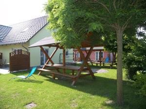 a picnic table and a chair in a yard at Ferienpark Neppermin Appartmenthäuser in Neppermin
