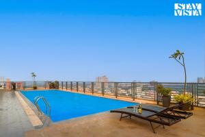 a swimming pool on the roof of a building at StayVista at Cityscape with Rooftop Pool - Jaipur in Jaipur