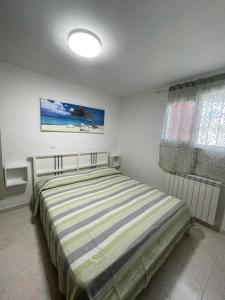 a bedroom with a bed in a room with a window at Spacious apartment with terrace - Beahost Rentals in Rosolina Mare