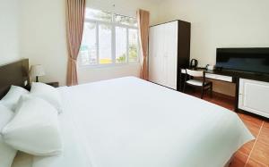 Postel nebo postele na pokoji v ubytování BIDV Central Da Lat Hotel