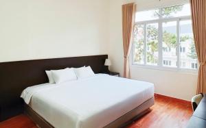 Postel nebo postele na pokoji v ubytování BIDV Central Da Lat Hotel