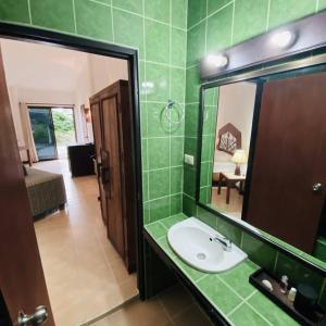 a bathroom with a sink and a mirror at La Casa Bianca Samui in Nathon Bay