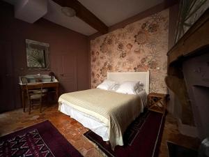 a bedroom with a bed and a table and a fireplace at Authentic Flat in Dijon in Dijon