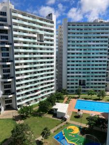 an aerial view of two large buildings with a swimming pool at The Residences at Commonwealth Quezon City by Snazzy Staycation in Manila