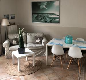 a living room with two tables and a couch at Villa Baltica Bungalow in Dahme