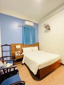 a bedroom with a bed and a blue wall at A25 Hotel - 197 Thanh Nhàn in Hanoi