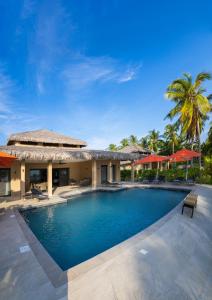 a swimming pool in front of a villa at Alma Villas in Nosy Be