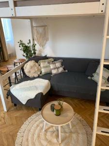 a living room with a blue couch and a bunk bed at Apartment Cecil - Old Town in Bratislava