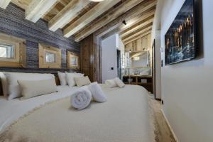 a bedroom with two beds with white pillows at Residence Les Rives De L Isere - 4 Pièces pour 6 Personnes 574 in Val-d'Isère