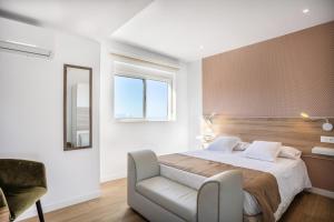 a bedroom with a bed and a chair and a mirror at Casa Senderos del Norte in Sauzal