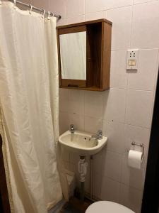 a bathroom with a sink and a toilet and a mirror at Barley Mow Hotel in Pontefract