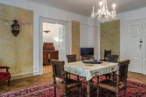 a dining room with a table and chairs and a chandelier at Luxury old Town Apartment in Prague