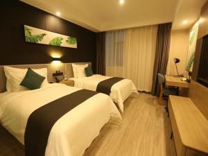 a hotel room with two beds and a desk at Thank Inn Chain Beijing Fanshan Chengguan Town Fangshan Red Scarf Park in Fangshan