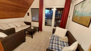 a living room with a couch and a table at Varjas apartman in Ábrahámhegy +2 photos