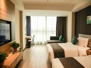 a hotel room with two beds and a television at Thank Inn Chain Suqian Hubin New District Santaishan Park in Suqian