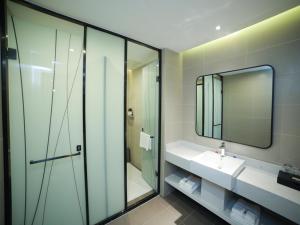 a bathroom with a sink and a mirror at Thank Inn Chain Xianyang Renmin Road Central Plaza in Xianyang
