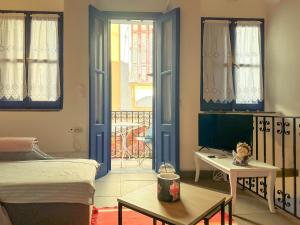 a bedroom with a bed and a room with a balcony at Kali Strata 2 - Downtown in Symi