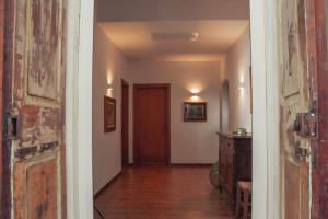 um corredor com uma porta e um quarto com uma mesa em The Tuscany Rose em Pistoia