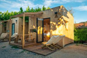 a small wooden house with a table and chairs at Kampaoh Playa de Levante in Benidorm