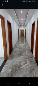 a hallway with a marble floor in a building at VTP Guest House in Bikaner