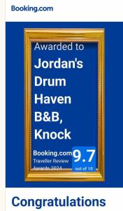 a picture of a framed sign on a blue background at Jordan's Drum Haven B&B, Knock in Knock
