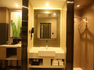 a bathroom with a sink and a mirror at Thank Inn Chain Beijing Fanshan Chengguan Town Fangshan Red Scarf Park in Fangshan