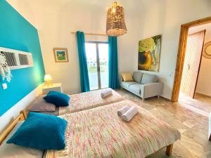 A bed or beds in a room at The Beachhouse Apartments