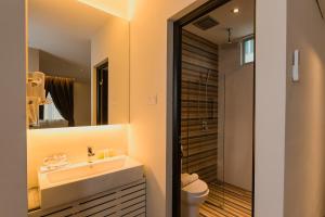 un bagno con lavandino, water e specchio di D Elegance Hotel Nusajaya a Nusajaya