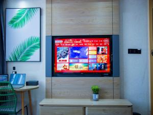 a television screen in a wall with a table at Thank Inn Chain Kashgar Bachu Junmin Road Balchuk Town in Pa-ch'u-hsien