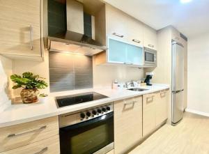 a kitchen with a sink and a stove at Fortuny Golden in Cambrils