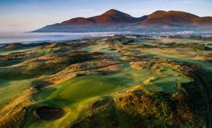 an aerial view of a golf course with mountains in the background at Scotts Lodge Newcastle County Down in Newcastle