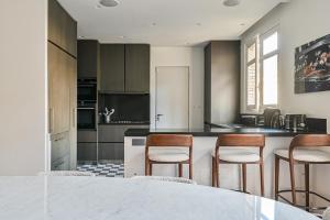 a kitchen with a table and chairs and a counter at Gorgeous Paris Eiffel Tower - Champs Elysées in Paris