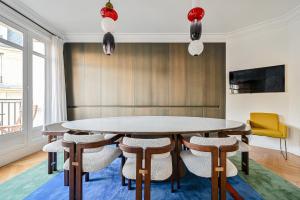 a dining room with a table and chairs at Gorgeous Paris Eiffel Tower - Champs Elysées in Paris