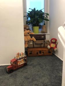 a room with a pile of luggage and a teddy bear at Stay Adventure Mrzeżyno in Mrzeżyno