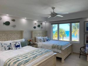 a bedroom with two beds with a view of the ocean at Luxury Beachfront 2 Bedroom at Wyndham Rio Mar, PR in Luquillo +58 photos