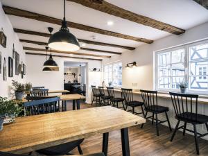 a dining room with wooden tables and chairs at Flecker Hotel in Freudenberg