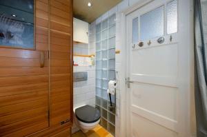 a bathroom with a toilet and a glass door at Apartment Sandra in Amsterdam