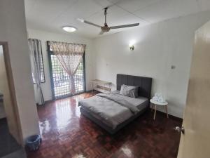 a bedroom with a bed and a table in it at Home Sweet Home in Sungai Petani