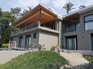 an image of a house with a balcony at Ubucuti Lodge in Gisenyi