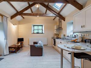 a kitchen with white cabinets and a counter top at Tiptoe Barn in Liskeard