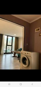 a washing machine in a room with a mirror at My home 1 in Kiketʼi