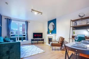 a living room with a couch and a table at Stylish Central Apartment with Free Parking, Fast WiFI and Smart TV by Yoko Property in Coventry