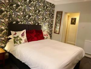 a bed with white sheets and pillows in a bedroom at Milton House Studio Apartments Askrigg in Askrigg