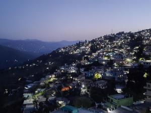 an aerial view of a city at night at Badriniwas homestays in Almora