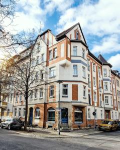 a large building on the corner of a street at NUWILU ONE - Apartment mit Balkon im Herzen Erfurts - Magenta TV- Netflix - Disney in Erfurt