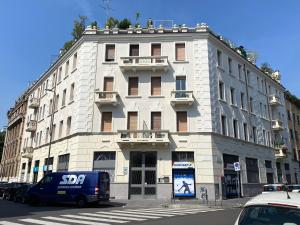 un bâtiment avec une camionnette bleue garée devant dans l'établissement Contempora Apartments - Breno 2, à Milan
