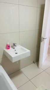 a white bathroom with a sink and a shower at 74 Chapel Towers - City Centre in Cape Town